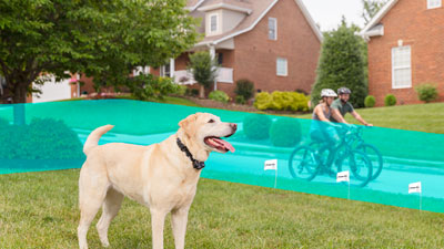 Graphic displaying how how in-ground fence system keeps dog in yard